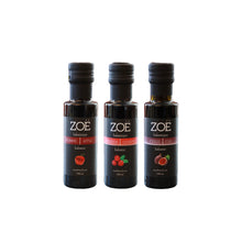 Three bottles of Zoe balsamic vinegar on a white background