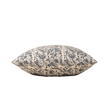 Blue floral patterned decorative pillow on its side on a white background