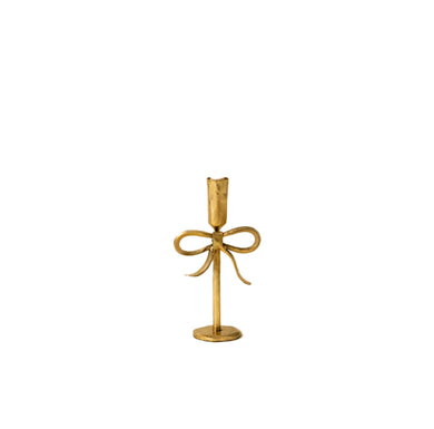 Short gold candle holder with bow design on a white background