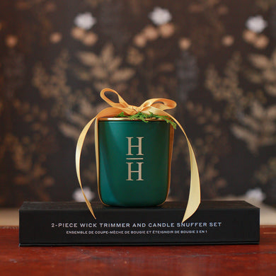 Green Candle on a black box wrapped in gold ribbon