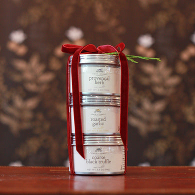 three different sea salt jars stacked and tied in red velvet ribbon
