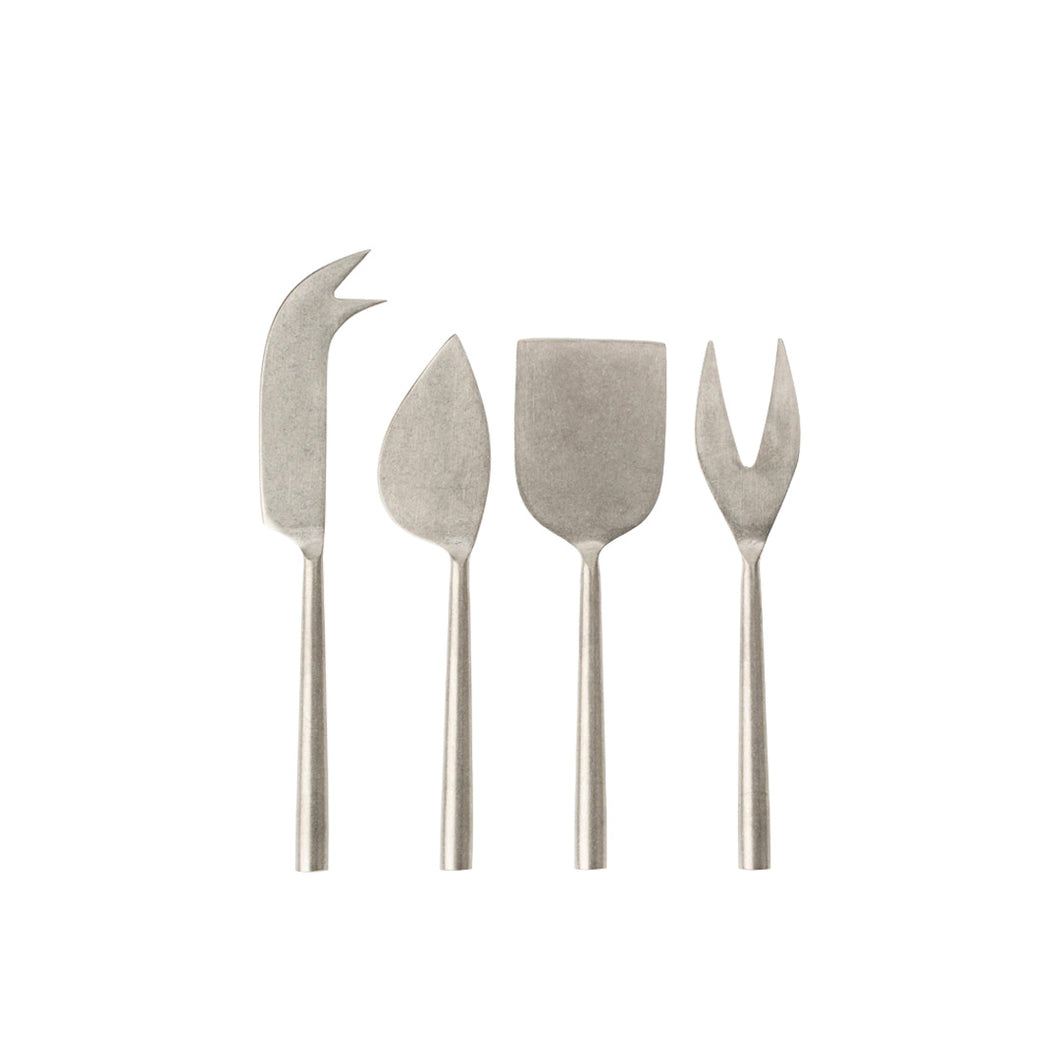 Set of four tumbled stainless steel cheese knives on a white background