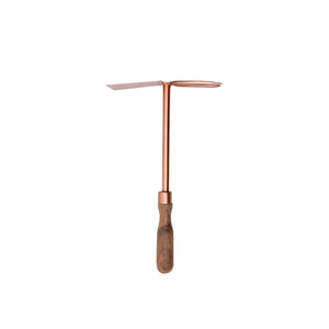 copper cultivator and hoe combo on a wooden handle
