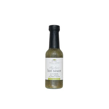 dilly jalapeno hot sauce in a glass bottle with a white background