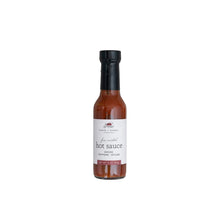 fire roasted hot sauce in a glass bottle with a white background