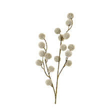 artificial spray branch with fuzzy pom poms on a white background