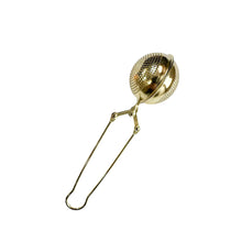 Gold coloured stainless steel tea steeper on a white background