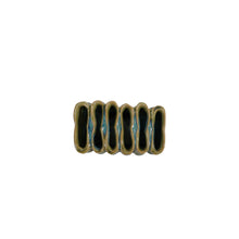 birds eye view of mini green ceramic vase with ribbed texture and divided sections on a white background