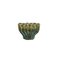 Small green ceramic vase with ribbed texture and divided sections on a white background