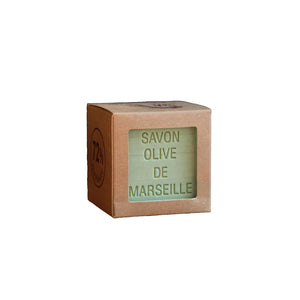 Cube of Savon Olive de Marseille soap in a cardboard box on a white background