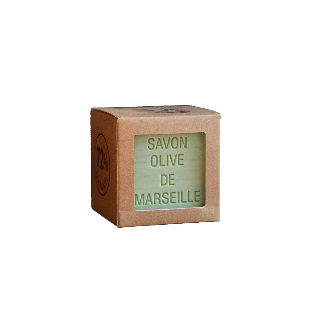 Cube of Savon Olive de Marseille soap in a cardboard box on a white background