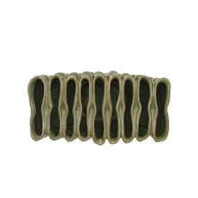 birds eye view of green ceramic vase with ribbed texture and divided sections on a white background