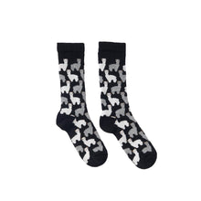 Black socks with alpaca pattern on a white background