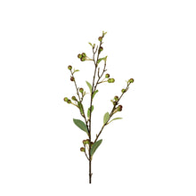 Artificial plant branch with green leaves and small berries on a white background