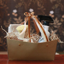 Gift basket with Kitchen supplies and a bow on a wooden surface