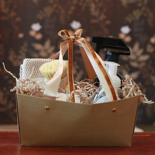 Gift basket with Kitchen supplies and a bow on a wooden surface