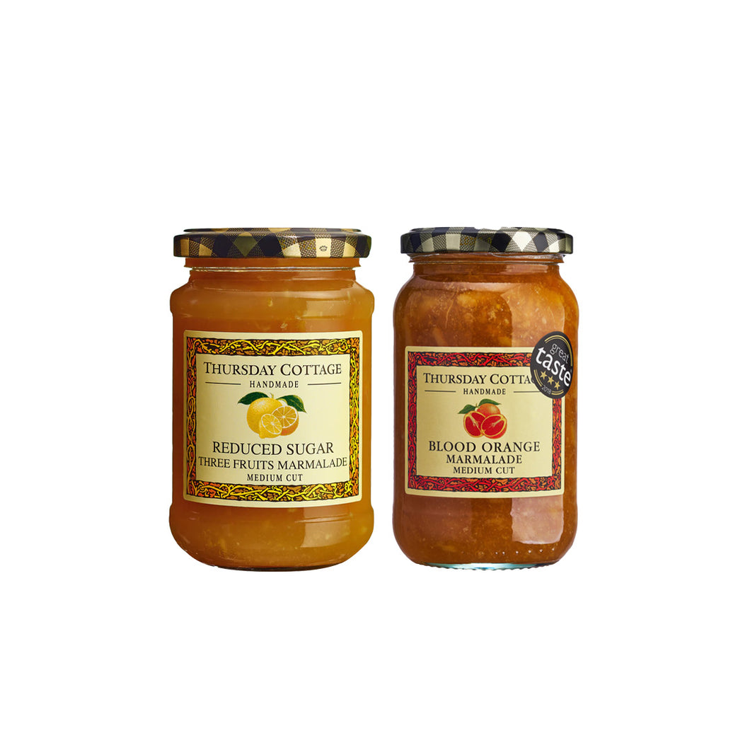 Two jars of Thursday Cottage marmalade on a white background