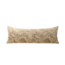 Decorative pillow with beige and brown floral pattern on a white background
