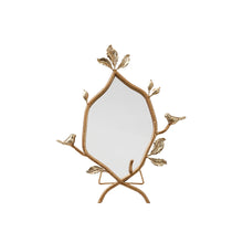 Decorative mirror with gold leaf and bird design on a white background