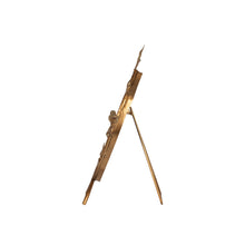 Decorative mirror with gold leaf and bird design on a white background from the side view with stand leaning