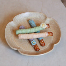 Decorative ceramic dish with colourful dipped pretzels