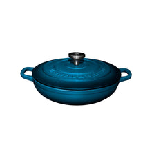 Blue cast iron cookware braiser pot with lid on a white background