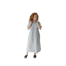 Woman wearing a navy and white striped dress on a white background