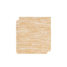 mustard yellow and white knit dish clothes folded on a white background
