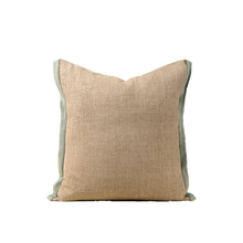 Beige linen pillow with mustard robins egg blue trim on a white background