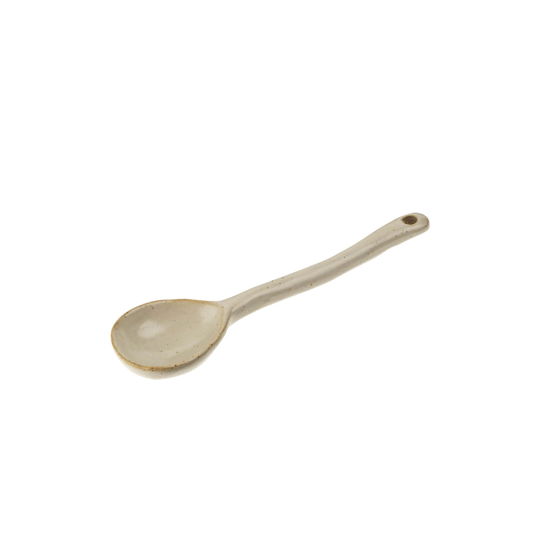 Beige ceramic spoon on a white background
