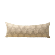 Beige decorative pillow with sun pattern on a white background