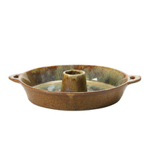 Ceramic dish with handles and toothpick holder from the side view on a white background