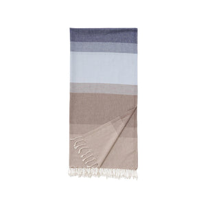 Color-blocked towel with stripes in blue, grey, and beige with tassels on a white background