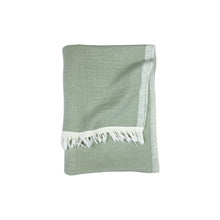 green towel with cream tassles
