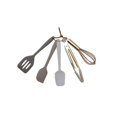 Set of silicone kitchen utensils including a spatula, ladle, whisk, and measuring spoons on a white background.