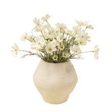 Artificial flower branches with white cosmos in a vase on a white background